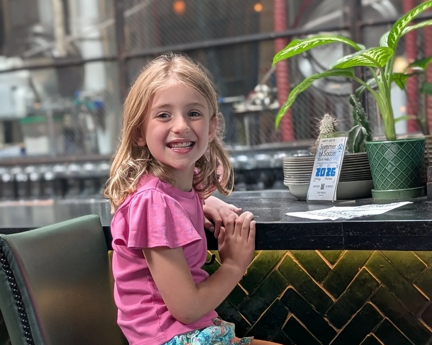 Abigail smiling in a pink shirt