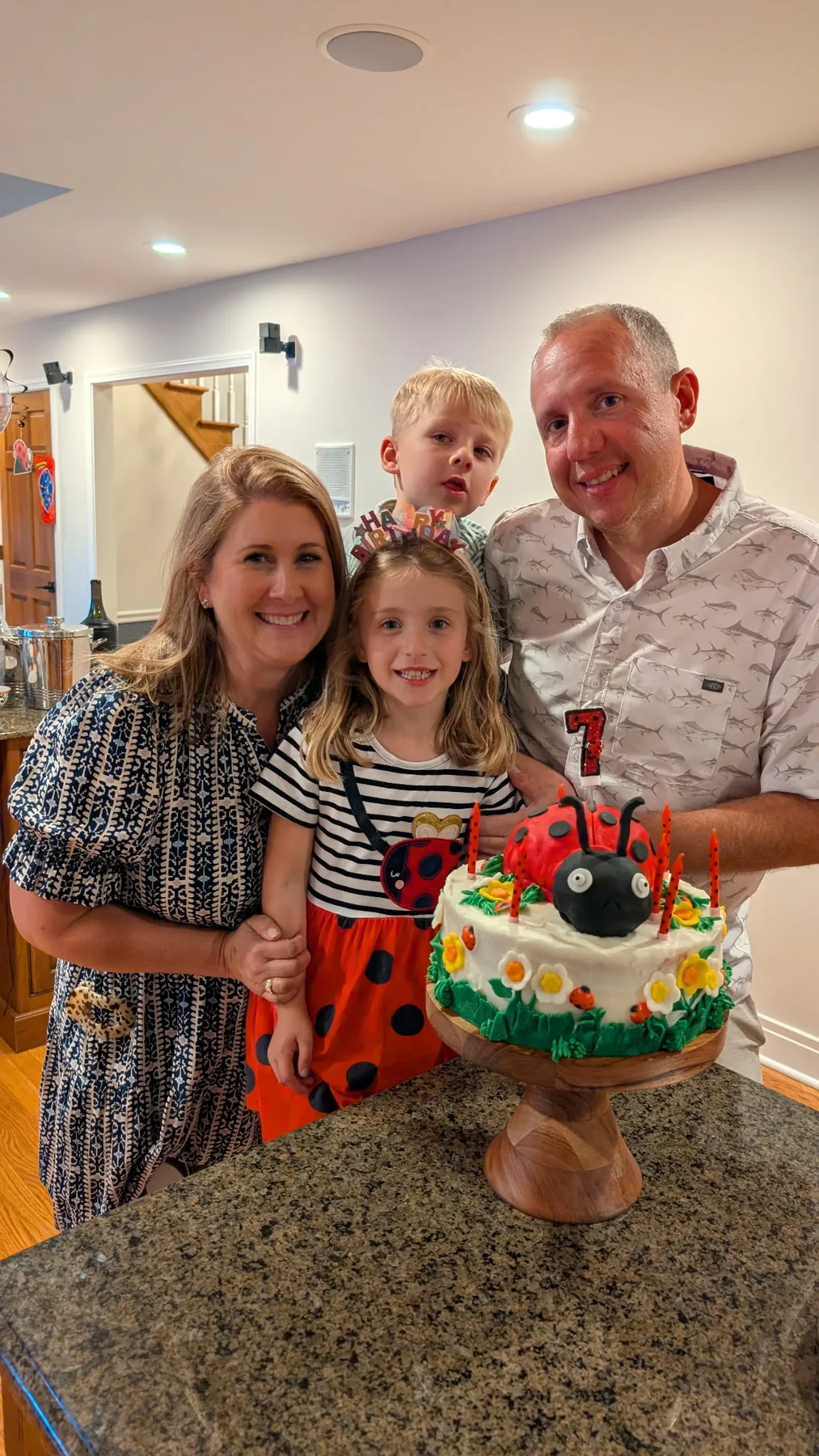 Abigail with her family and a decorated birthday cake