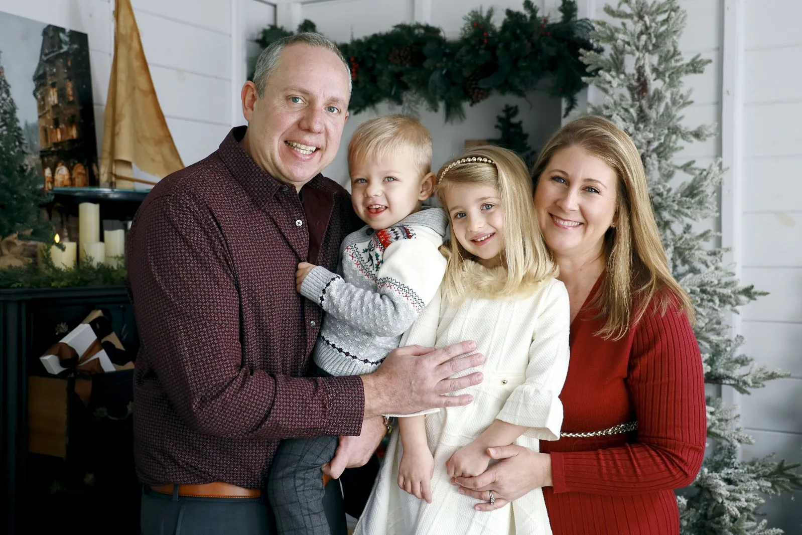 The Oswald family dressed up in front of a Christmas tree