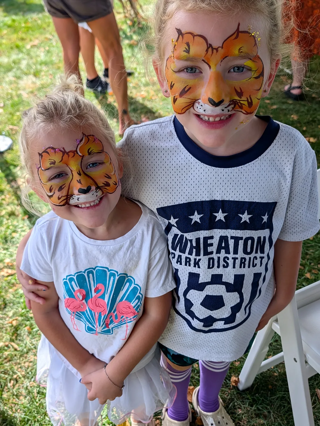 Two children with tiger face paint smiling at the Fall Festival
