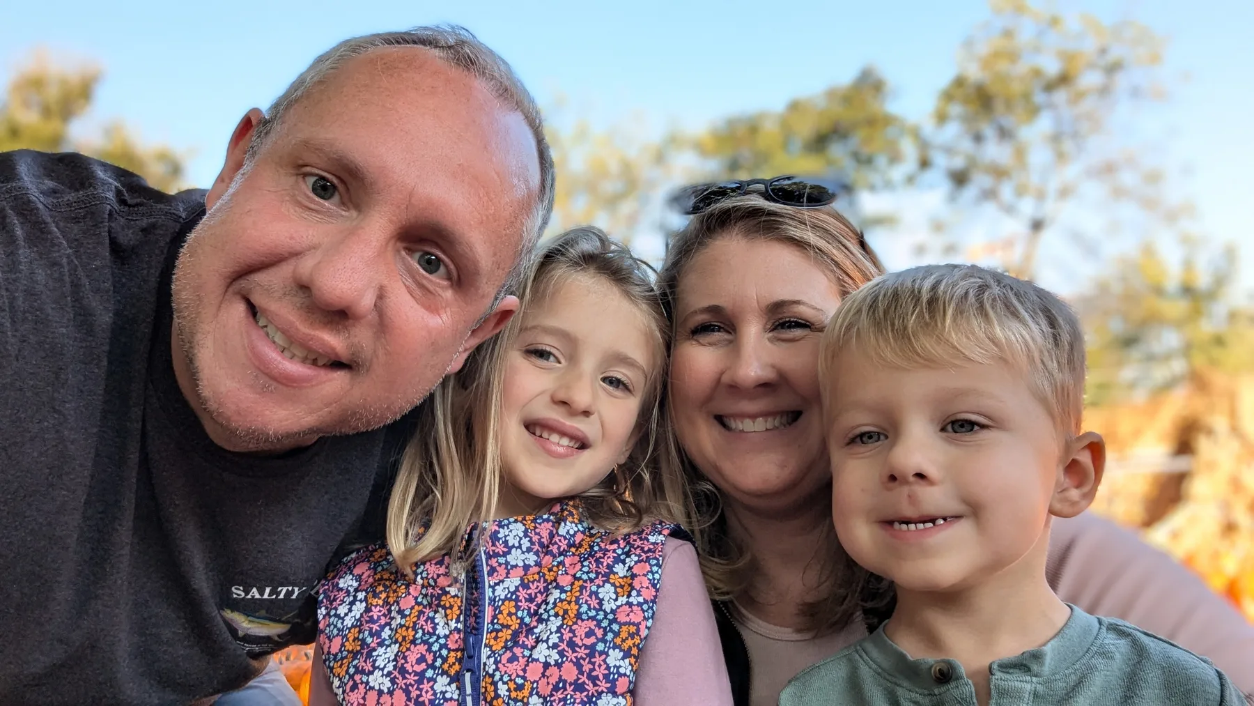 The Oswald family together outdoors on an autumn day