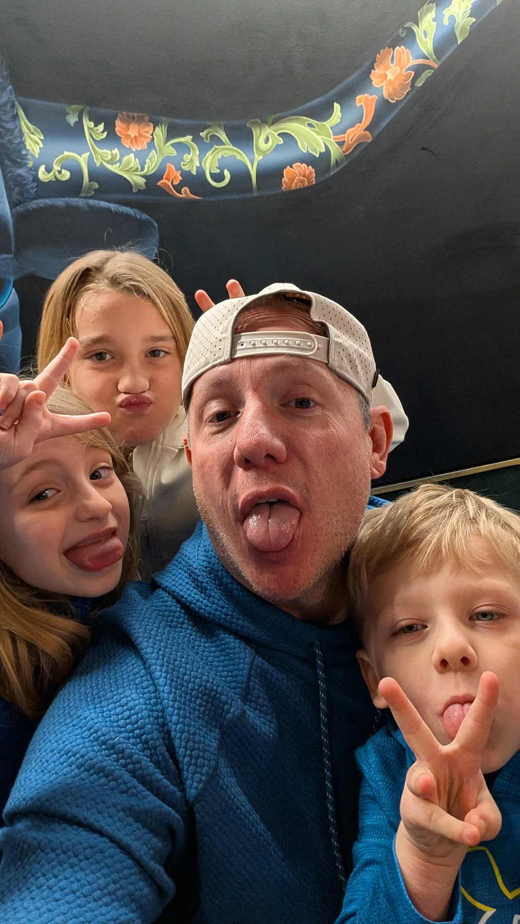 The family making silly faces together in a selfie